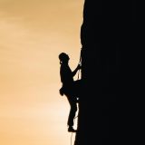 a man climbing a vertical wall