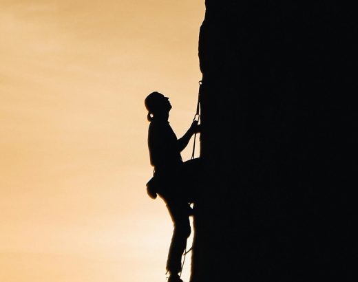 a man climbing a vertical wall